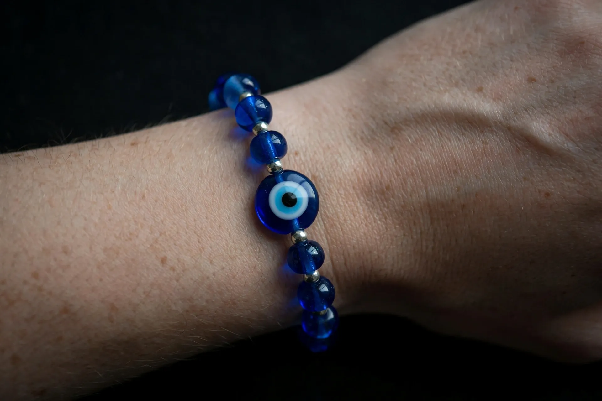 Blue evil eye protection bracelet worn on a wrist
