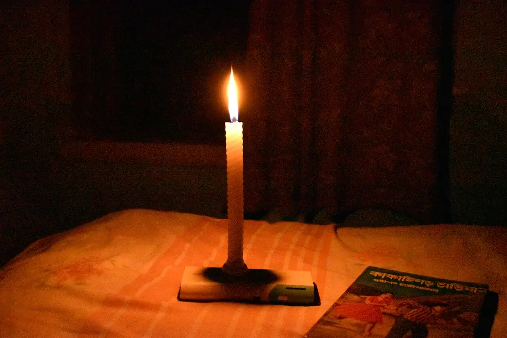 Why a home aura shield breaks down — a single candle in a dark room (Wikimedia Commons)